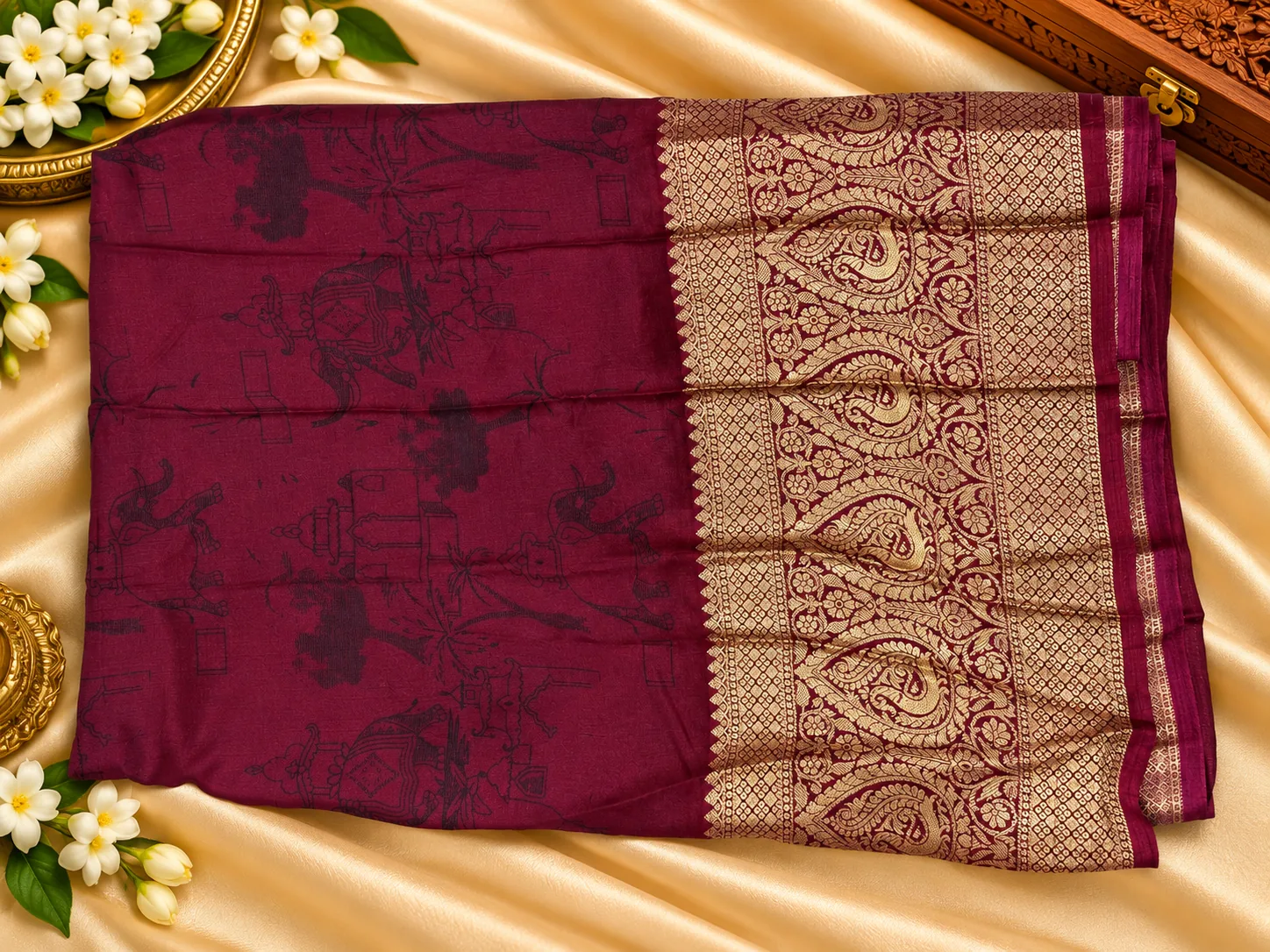 Maroon blouse piece of the navy fancy saree with zari border