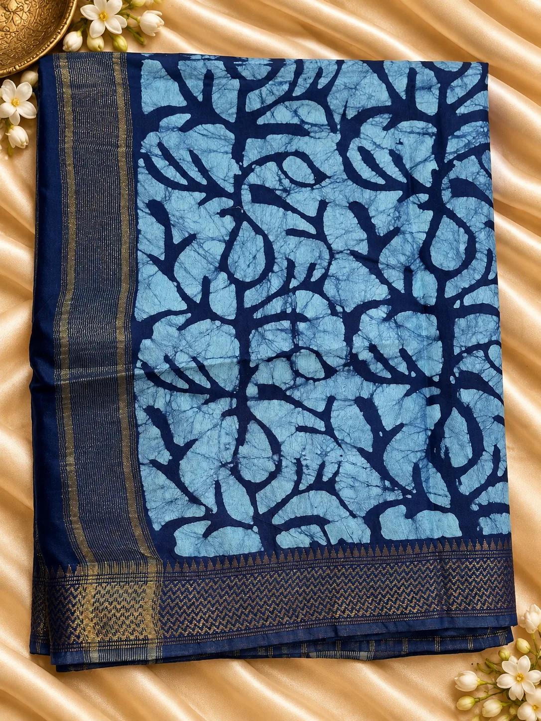 Blue Lenin Cotton saree, folded, with batik-style print and navy border