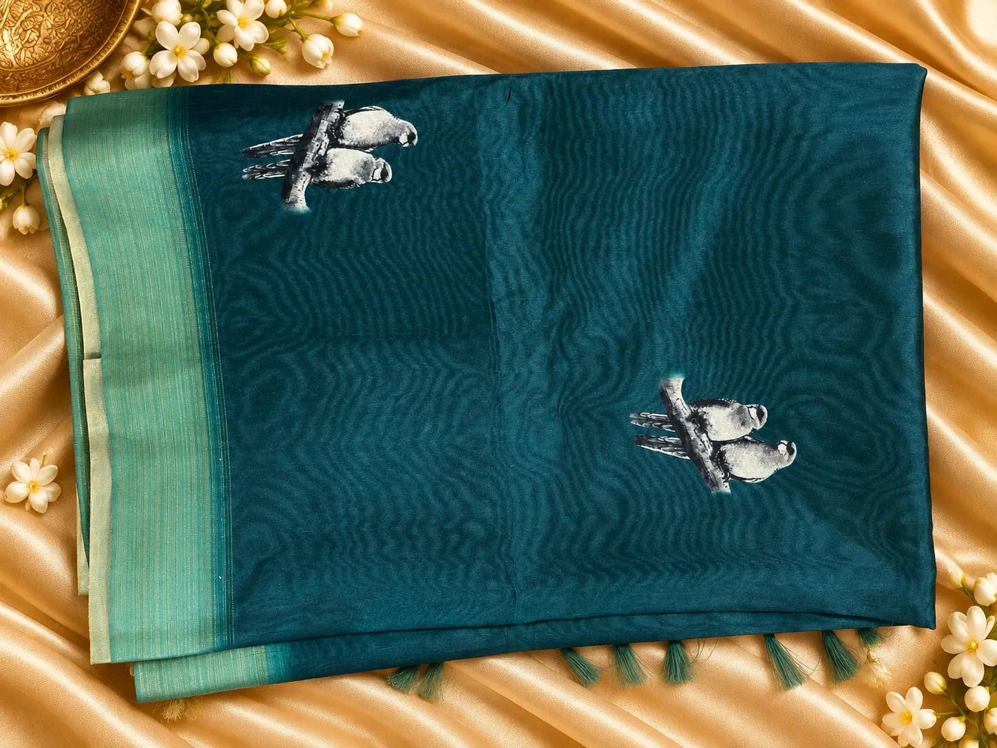 Teal Cora Fancy Saree, folded, with small embroidered birds